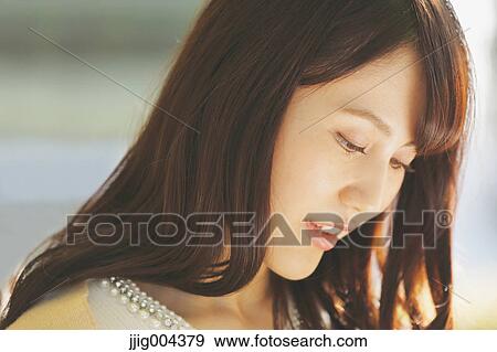 Young Japanese woman in a city park View Large Photo Image Stock Photo - Young Japanese woman in a city park. Fotosearch