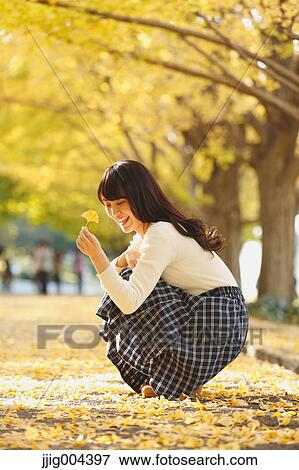 Young Japanese woman in a city park View Large Photo Image Stock Photo - Young Japanese woman in a city park. Fotosearch