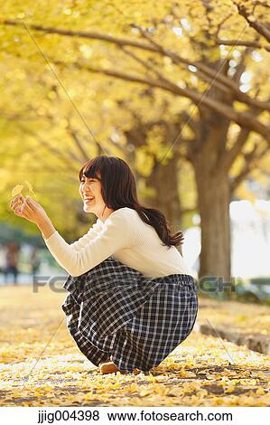 Young Japanese woman in a city park View Large Photo Image Stock Photo - Young Japanese woman in a city park. Fotosearch