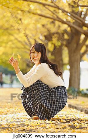 Young Japanese woman in a city park View Large Photo Image Stock Photo - Young Japanese woman in a city park. Fotosearch