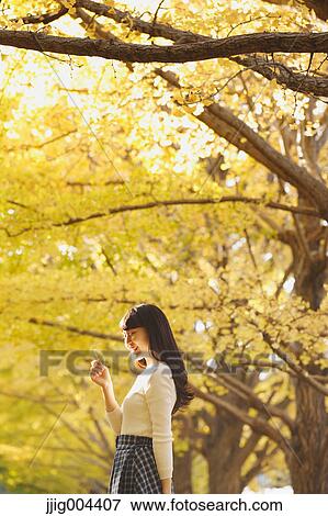 Young Japanese woman in a city park View Large Photo Image Stock Photo - Young Japanese woman in a city park. Fotosearch