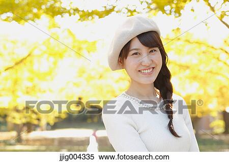 Young Japanese woman in a city park View Large Photo Image Stock Photography - Young Japanese woman in a city park. Fotosearch