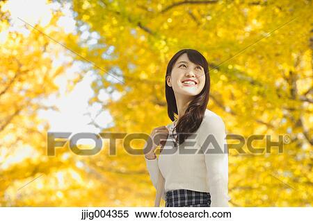 Stock Photography - Young Japanese woman in a city park. Fotosearch