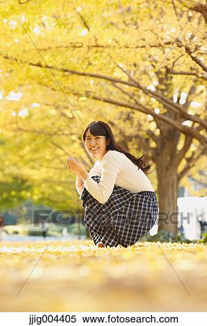 Young Japanese woman in a city park View Large Photo Image Stock Photography - Young Japanese woman in a city park. Fotosearch