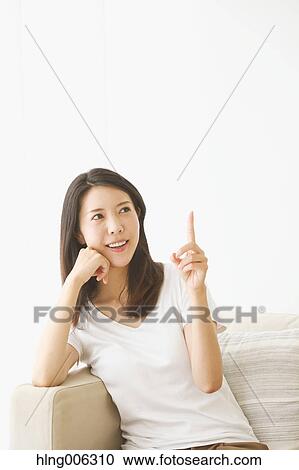 Young Japanese woman on the sofa in a white room View Large Photo Image Stock Image - Young Japanese woman on the sofa in a white room. Fotosearch