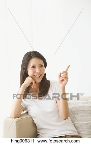 Young Japanese woman on the sofa in a white room View Large Photo Image Stock Image - Young Japanese woman on the sofa in a white room. Fotosearch