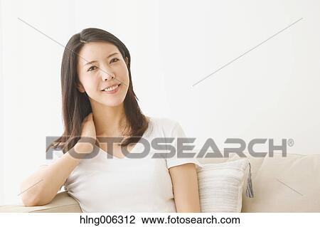 Young Japanese woman on the sofa in a white room View Large Photo Image Stock Image - Young Japanese woman on the sofa in a white room. Fotosearch