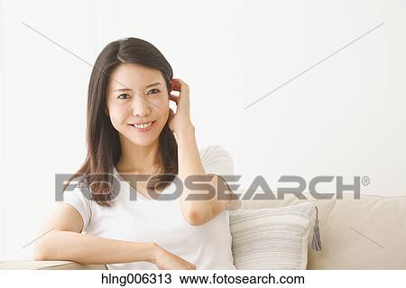 Young Japanese woman on the sofa in a white room View Large Photo Image Stock Image - Young Japanese woman on the sofa in a white room. Fotosearch