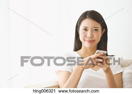 Young Japanese woman on the sofa in a white room View Large Photo Image Stock Image - Young Japanese woman on the sofa in a white room. Fotosearch