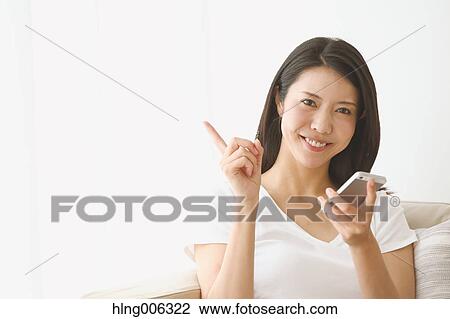 Young Japanese woman on the sofa in a white room View Large Photo Image Stock Image - Young Japanese woman on the sofa in a white room. Fotosearch