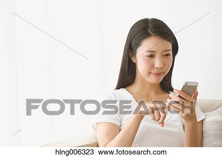 Young Japanese woman on the sofa in a white room View Large Photo Image Stock Image - Young Japanese woman on the sofa in a white room. Fotosearch