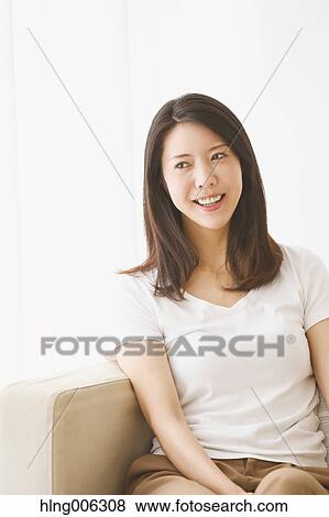 Young Japanese woman on the sofa in a white room View Large Photo Image Stock Photo - Young Japanese woman on the sofa in a white room. Fotosearch