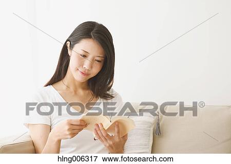 Young Japanese woman on the sofa in a white room View Large Photo Image Stock Photo - Young Japanese woman on the sofa in a white room. Fotosearch