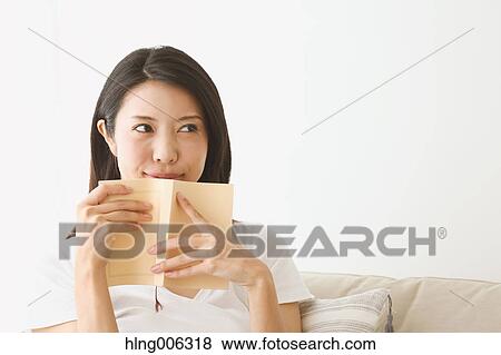 Young Japanese woman on the sofa in a white room View Large Photo Image Stock Photo - Young Japanese woman on the sofa in a white room. Fotosearch