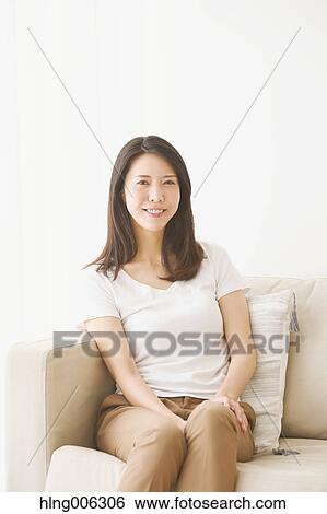 Young Japanese woman on the sofa in a white room View Large Photo Image Stock Photograph - Young Japanese woman on the sofa in a white room. Fotosearch