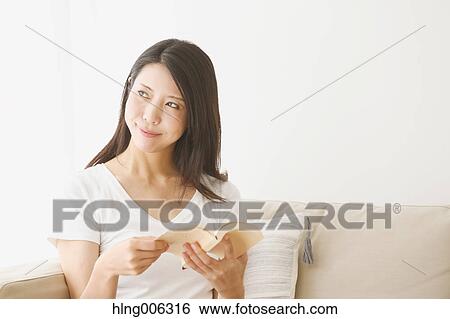 Young Japanese woman on the sofa in a white room View Large Photo Image Stock Photograph - Young Japanese woman on the sofa in a white room. Fotosearch