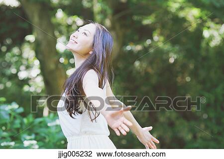 Young Japanese woman surrounded by green in a city park View Large Photo Image Stock Image - Young Japanese woman surrounded by green in a city park. Fotosearch