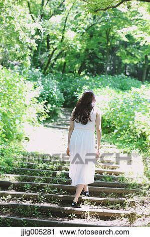 Young Japanese woman surrounded by green in a city park View Large Photo Image Stock Image - Young Japanese woman surrounded by green in a city park. Fotosearch