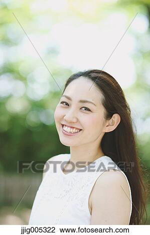 Young Japanese woman surrounded by green in a city park View Large Photo Image Stock Image - Young Japanese woman surrounded by green in a city park. Fotosearch