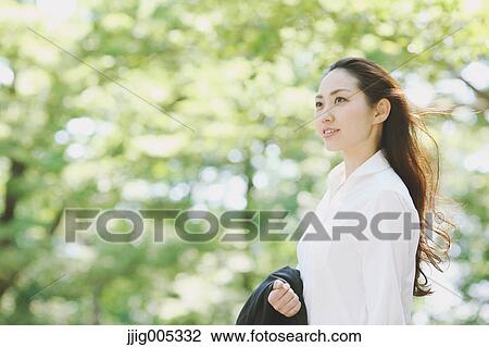 Young Japanese woman surrounded by green in a city park View Large Photo Image Stock Image - Young Japanese woman surrounded by green in a city park. Fotosearch