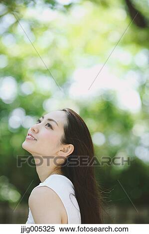 Young Japanese woman surrounded by green in a city park View Large Photo Image Stock Photography - Young Japanese woman surrounded by green in a city park. Fotosearch