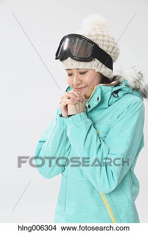 Picture - Young Japanese woman wearing snowboard wear on white background. Fotosearch