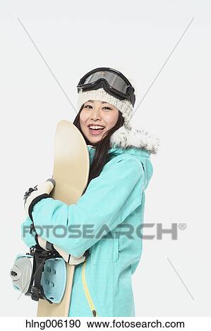 Young Japanese woman wearing snowboard wear on white background View Large Photo Image Stock Image - Young Japanese woman wearing snowboard wear on white background. Fotosearch