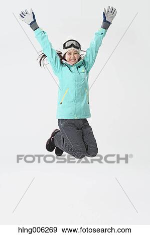 Stock Photo - Young Japanese woman wearing snowboard wear on white background. Fotosearch