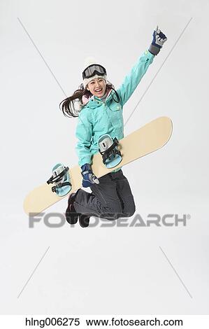 Stock Photography - Young Japanese woman wearing snowboard wear on white background. Fotosearch