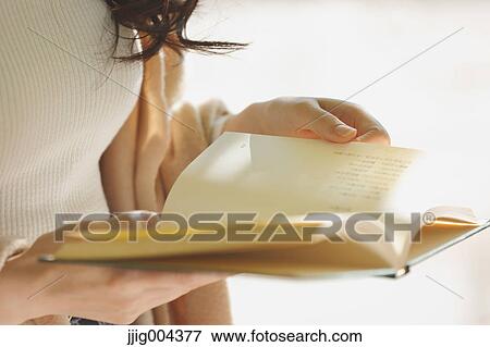 Young Japanese woman with book in a city park View Large Photo Image Stock Photo - Young Japanese woman with book in a city park. Fotosearch