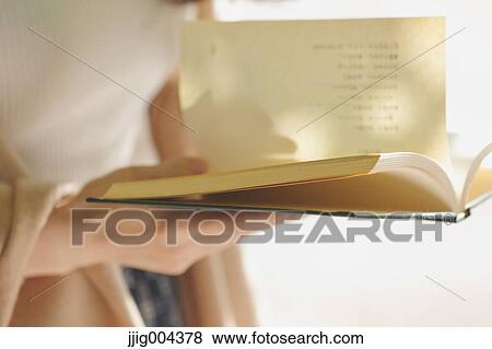 Young Japanese woman with book in a city park View Large Photo Image Stock Photo - Young Japanese woman with book in a city park. Fotosearch