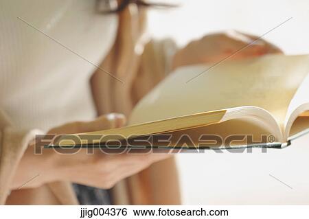 Young Japanese woman with book in a city park View Large Photo Image Stock Photograph - Young Japanese woman with book in a city park. Fotosearch