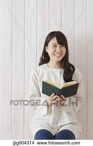 Young Japanese woman with book View Large Photo Image Picture - Young Japanese woman with book. Fotosearch