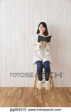 Young Japanese woman with book View Large Photo Image Stock Image - Young Japanese woman with book. Fotosearch