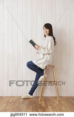Young Japanese woman with book View Large Photo Image Stock Image - Young Japanese woman with book. Fotosearch