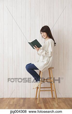 Young Japanese woman with book View Large Photo Image Stock Photo - Young Japanese woman with book. Fotosearch
