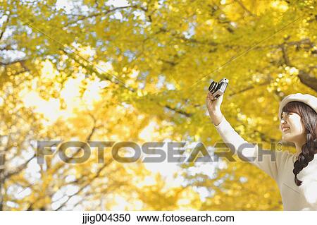 Young Japanese woman with vintage camera in a city park View Large Photo Image Stock Image - Young Japanese woman with vintage camera in a city park. Fotosearch