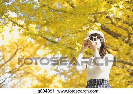 Young Japanese woman with vintage camera in a city park View Large Photo Image Stock Image - Young Japanese woman with vintage camera in a city park. Fotosearch