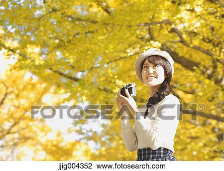 Young Japanese woman with vintage camera in a city park View Large Photo Image Stock Image - Young Japanese woman with vintage camera in a city park. Fotosearch
