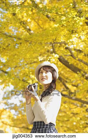 Young Japanese woman with vintage camera in a city park View Large Photo Image Stock Image - Young Japanese woman with vintage camera in a city park. Fotosearch