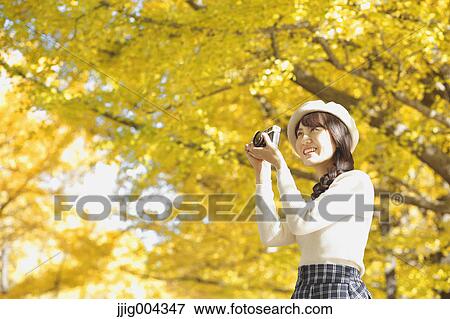 Young Japanese woman with vintage camera in a city park View Large Photo Image Stock Photo - Young Japanese woman with vintage camera in a city park. Fotosearch