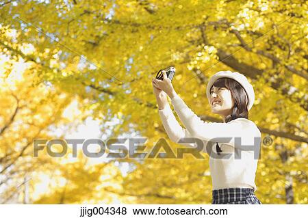 Young Japanese woman with vintage camera in a city park View Large Photo Image Stock Photo - Young Japanese woman with vintage camera in a city park. Fotosearch