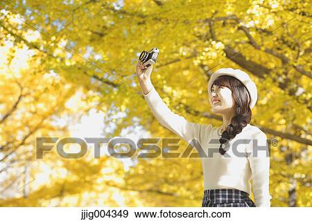 Young Japanese woman with vintage camera in a city park View Large Photo Image Stock Photo - Young Japanese woman with vintage camera in a city park. Fotosearch