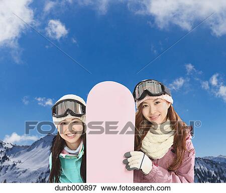 Stock Photo - Young Japanese women snowboarding. Fotosearch