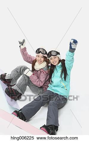 Stock Photography - Young Japanese women wearing snowboard wear on white background. Fotosearch