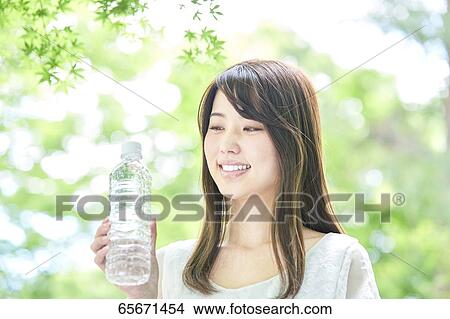 Attractive Japanese woman in a city park View Large Photo Image Picture - Attractive Japanese woman in a city park. Fotosearch