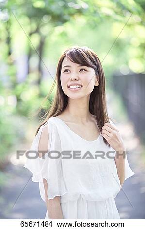Attractive Japanese woman in a city park View Large Photo Image Picture - Attractive Japanese woman in a city park. Fotosearch