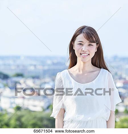 Attractive Japanese woman in a city park View Large Photo Image Picture - Attractive Japanese woman in a city park. Fotosearch