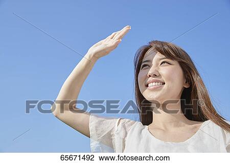 Attractive Japanese woman in a city park View Large Photo Image Stock Image - Attractive Japanese woman in a city park. Fotosearch