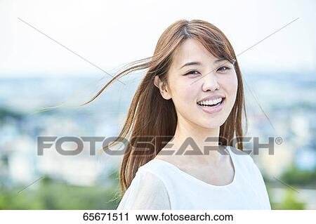 Attractive Japanese woman in a city park View Large Photo Image Stock Image - Attractive Japanese woman in a city park. Fotosearch